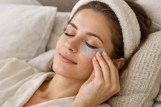 Person applying cooling under eye patch to under eye area